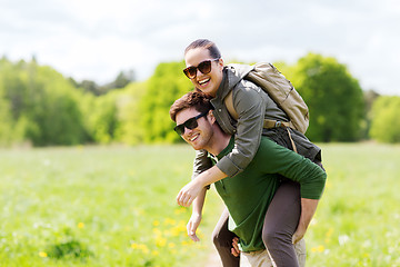 Image showing happy couple with backpacks having fun outdoors