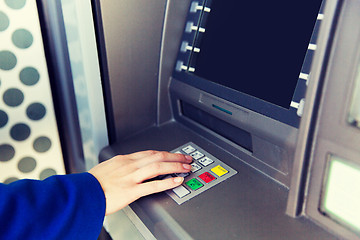 Image showing close up of hand entering pin code at cash machine