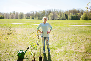 Image showing happy young volunteer woman outdoors