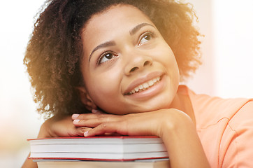 Image showing happy african student girl with books at home