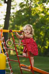 Image showing The little baby girl playing at outdoor playground