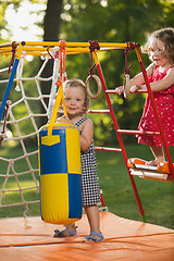 Image showing The two little baby girls playing at outdoor playground