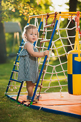 Image showing The little baby girl playing at outdoor playground