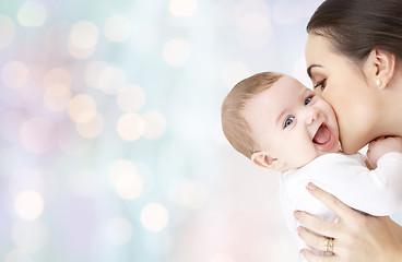 Image showing happy mother kissing adorable baby