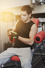 Image showing young man with smartphone in gym