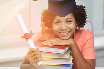 Image showing happy african bachelor girl with books and diploma