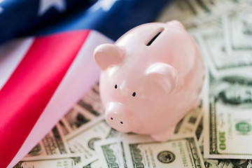 Image showing close up of american flag, piggy bank and money