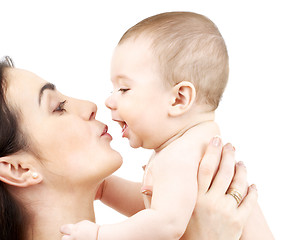 Image showing mother kissing adorable baby