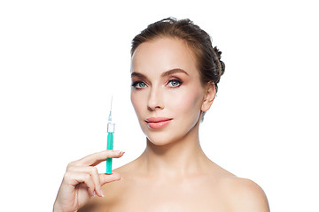 Image showing beautiful woman holding syringe with injection