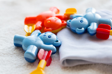 Image showing close up of baby rattle and clothes for newborn