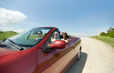 Image showing happy friends driving in cabriolet car