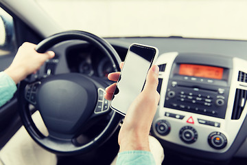 Image showing close up of man hand with smartphone driving car