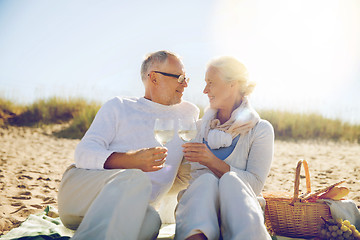 Image showing happy senior couple talking on summer beach