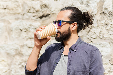 Image showing man drinking coffee from paper cup on street