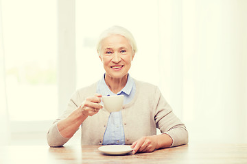 Image showing happy senior woman with cup of coffee