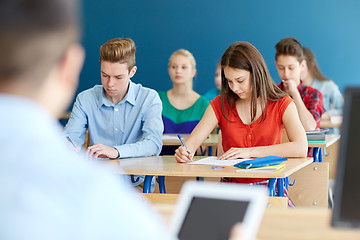 Image showing group of students with books writing school test