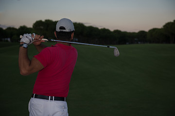 Image showing golfer hitting a sand bunker shot on sunset