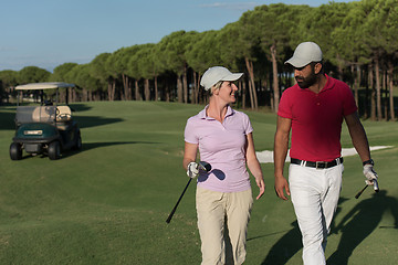 Image showing couple walking on golf course