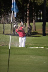 Image showing golfer hitting a sand bunker shot