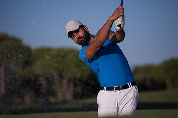 Image showing pro golfer hitting a sand bunker shot