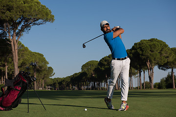 Image showing golf player hitting shot