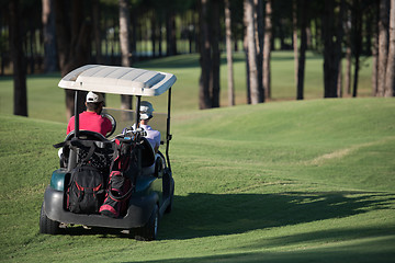 Image showing couple in buggy on golf course