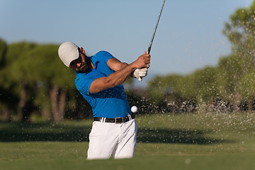 Image showing pro golfer hitting a sand bunker shot