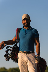 Image showing golfer  portrait at golf course on sunset