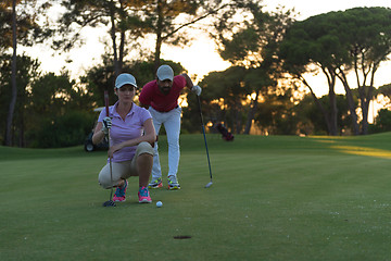 Image showing couple on golf course at sunset