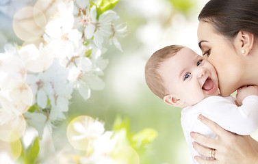 Image showing happy mother kissing adorable baby