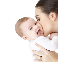 Image showing mother kissing adorable baby