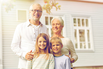 Image showing happy family in front of house outdoors