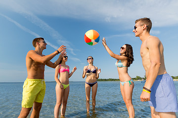 Image showing smiling friends in sunglasses on summer beach