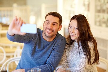 Image showing couple taking smartphone selfie at cafe restaurant