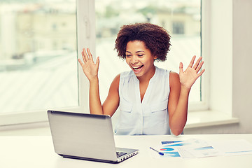 Image showing happy african woman with laptop at office