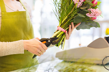 Image showing close up of florist woman with flowers and pruner