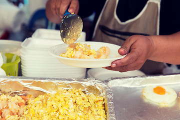 Image showing close up of hands with wok at street market