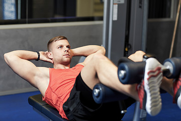 Image showing young man making abdominal exercises in gym