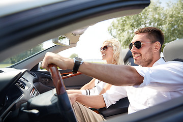 Image showing happy man and woman driving in cabriolet car