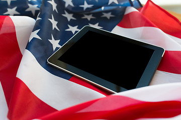 Image showing close up of tablet pc computer on american flag