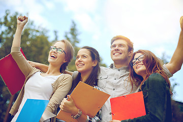 Image showing group of happy students showing triumph gesture