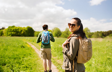 Image showing happy couple with backpacks hiking outdoors