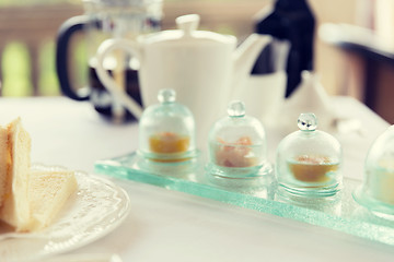 Image showing close up of tea time set with jam on table