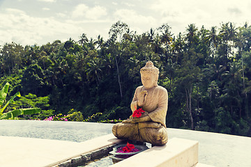 Image showing infinity edge pool with buddha statue