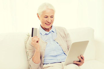 Image showing senior woman with tablet pc and credit card