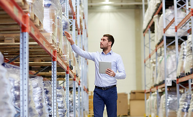 Image showing businessman with tablet pc at warehouse