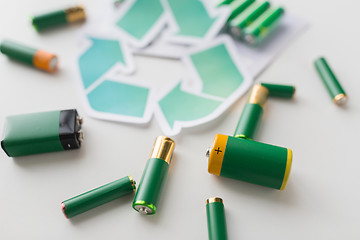 Image showing close up of batteries and green recycling symbol