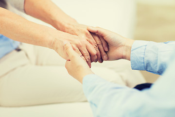 Image showing close up of senior and young woman hands