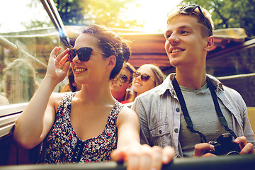 Image showing smiling couple with camera traveling by tour bus