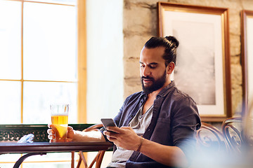 Image showing man with smartphone drinking beer at bar or pub